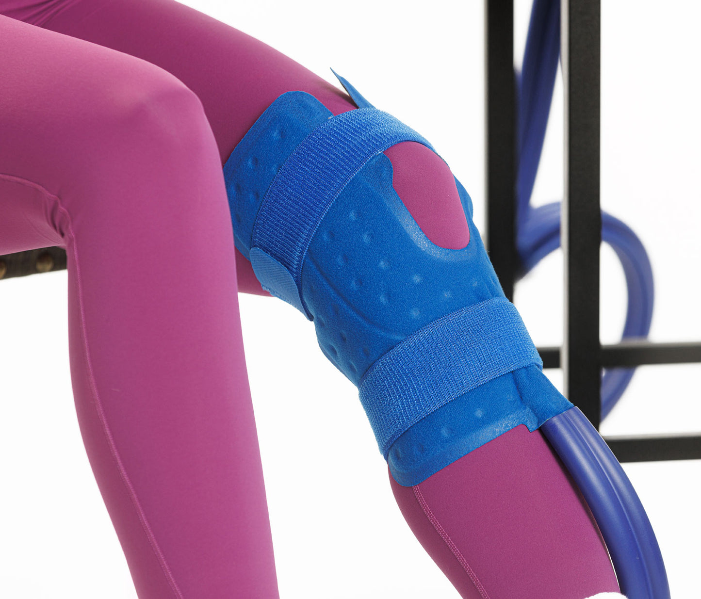 A close up of a knee with a cooling pad on it.