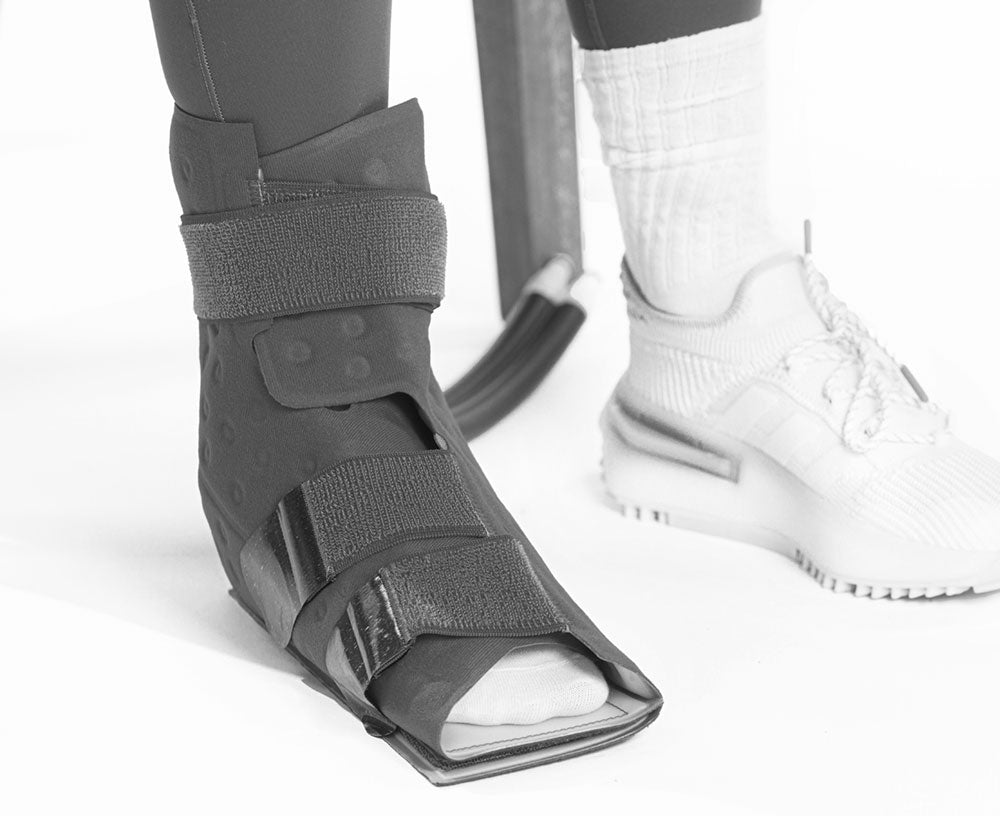 A close up of a foot with a cooling pad on it.