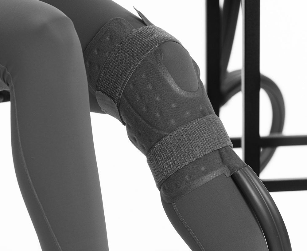 A close up of a knee with a cooling pad on it.