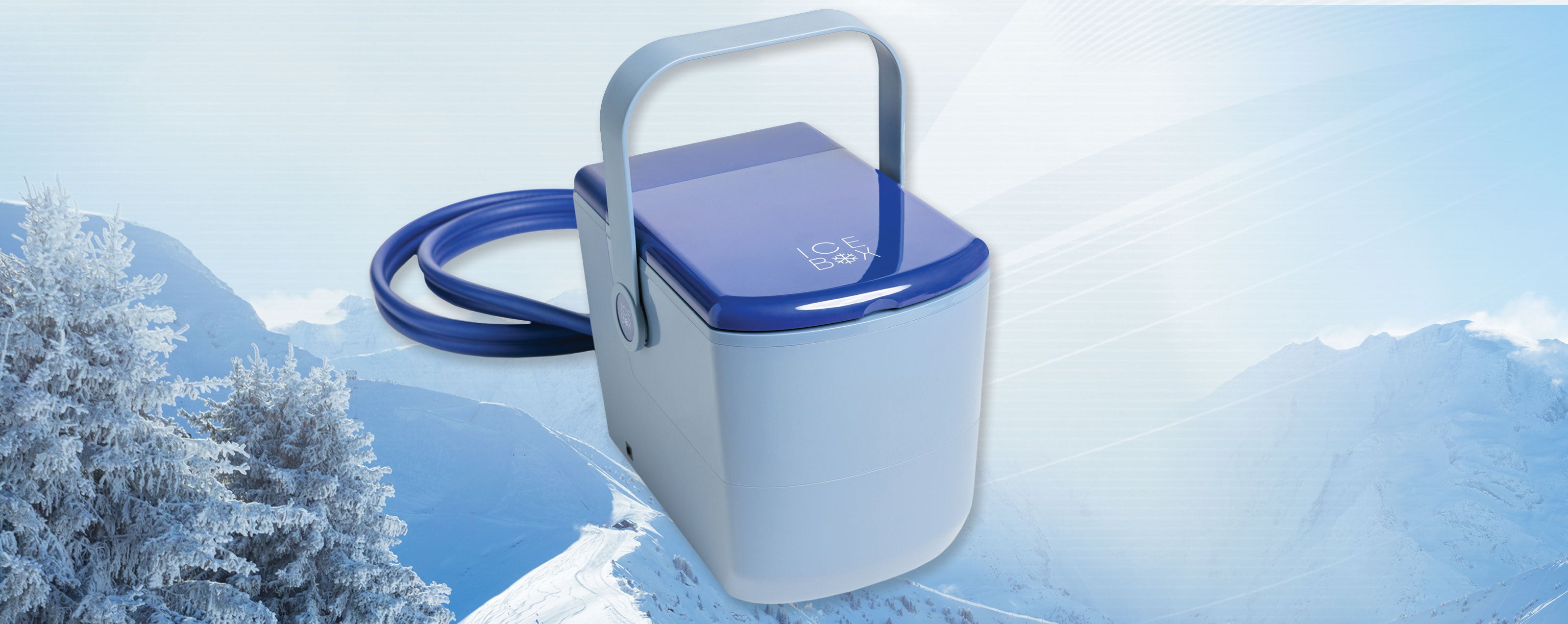 The Ice Box cold therapy device shown with snowy mountains and trees against a sunny sky.